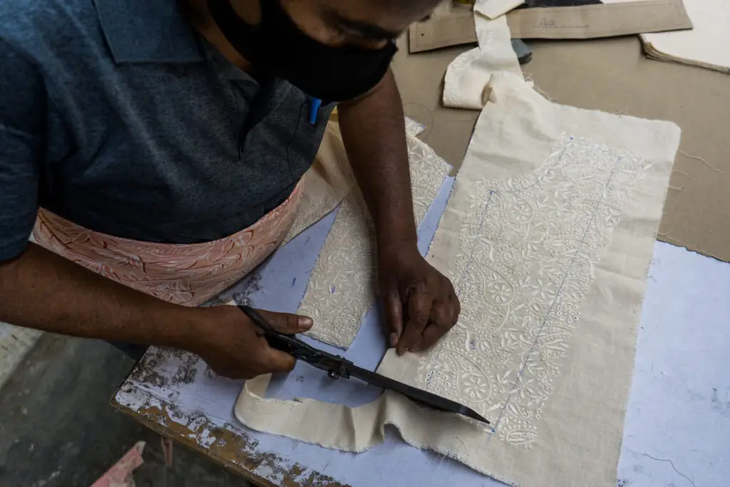 factory worker cutting a fabric