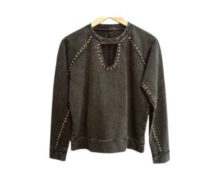 golden stud work on black sweat top