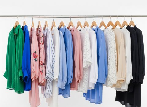 High-quality women’s apparel samples on rack — showcasing various fabrics, silhouettes, and seasonal color palettes.