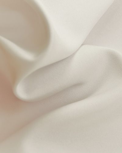 close up of a creme color fabric with soft lighting