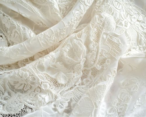closeup of white lace fabric sourced by Zeddwork Studio for luxury brand